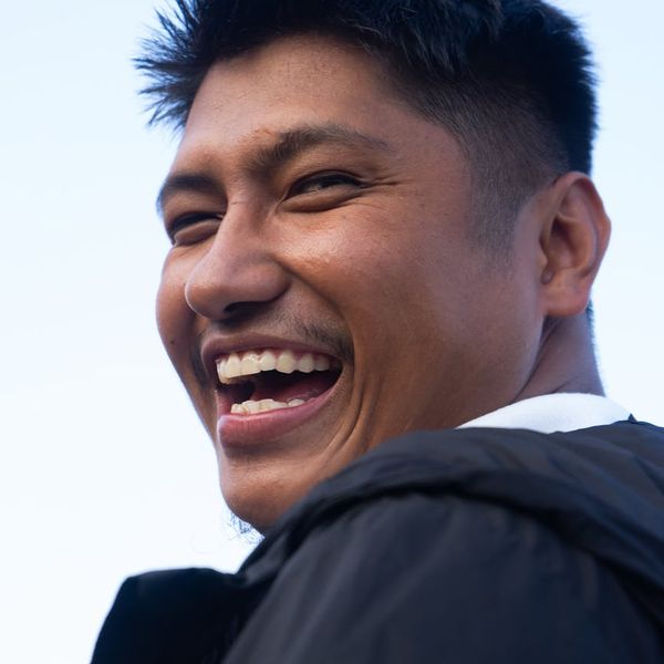 Person feeling energetic and positive in a bright room.